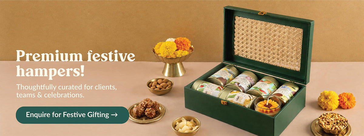 Premium festive gift hamper in a green cane box with healthy snack jars, for clients and teams